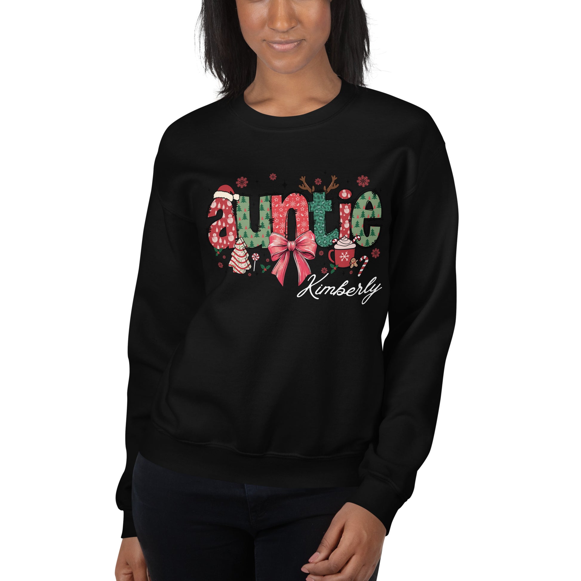 Model wearing Festive ‘Auntie’ Christmas sweatshirt in black with bow, Santa hat, and tree, customizable with name.
