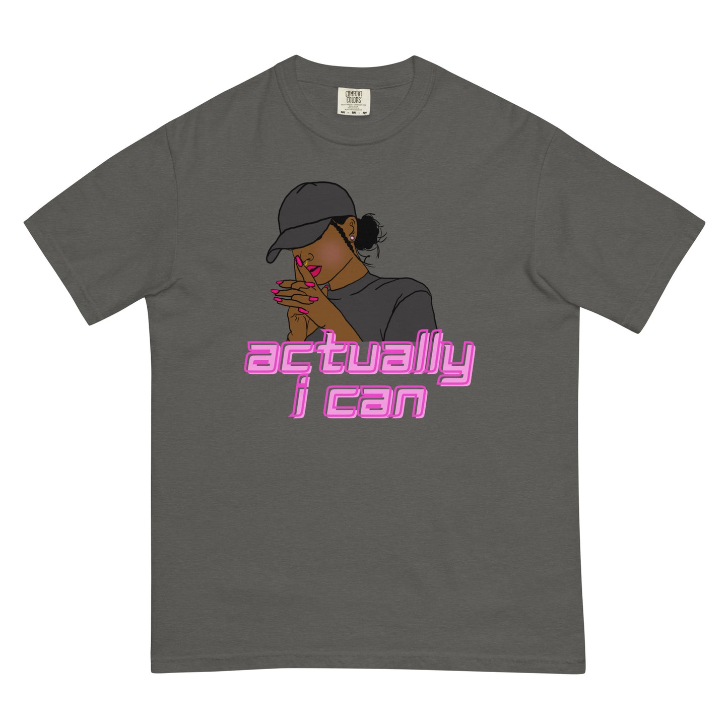 A women of color wearing a baseball cap in a thinking yet motivated posture above the words, Actually I can in pink on a pepper shirt on a white background.