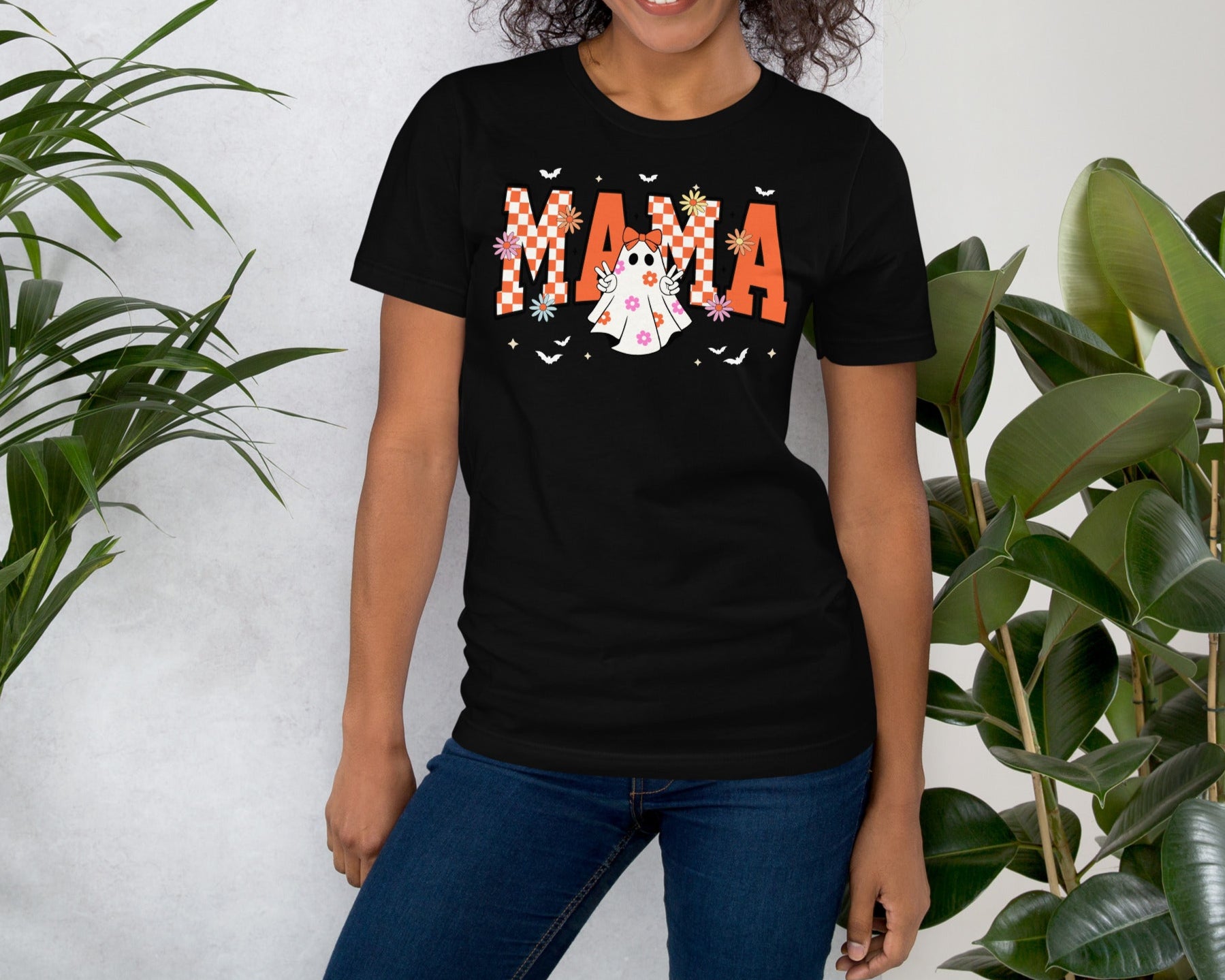 Woman wearing Groovy Momma Halloween tee in black with ghost and lightning bolt – retro spooky mom shirt