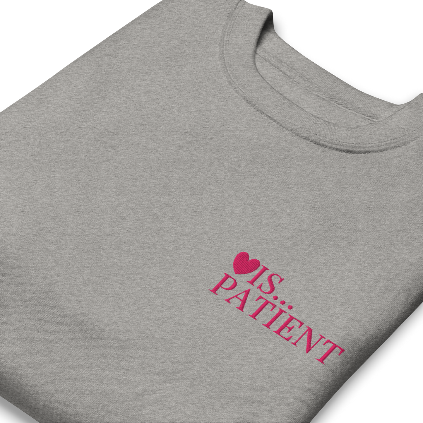 Gray t-shirt with 'Love is Patient' text and heart symbol on a white background