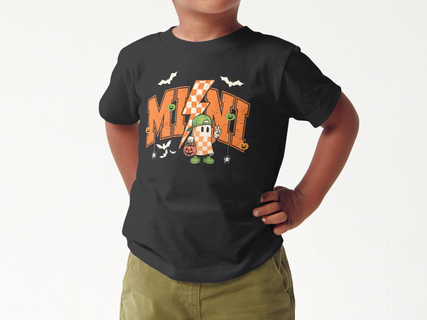 (modeled on a child) while wearing a black Halloween toddler tee, with a ghost,and lightning bolt.